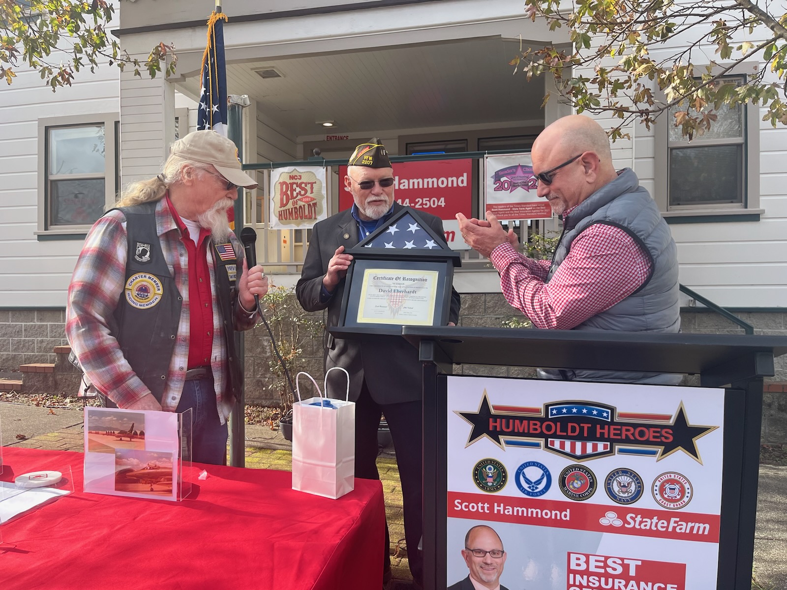 David Eberhardt receiving a folded flag and Certificate of Recognition at a Humboldt Heroes ceremony